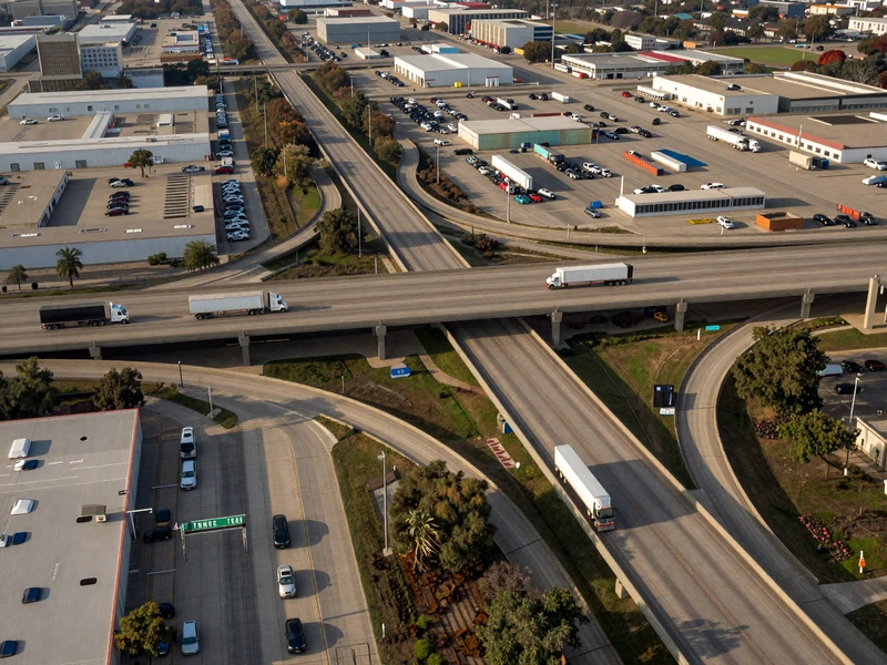 Aerial view of Dallas-Fort Worth interstate interchange with semi-trucks crossing I-35 and I-20